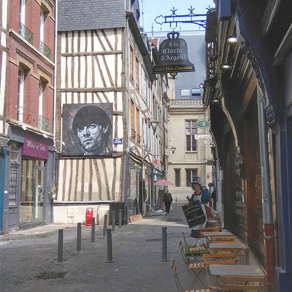 side road in Rouen with street art of Jean D'arc