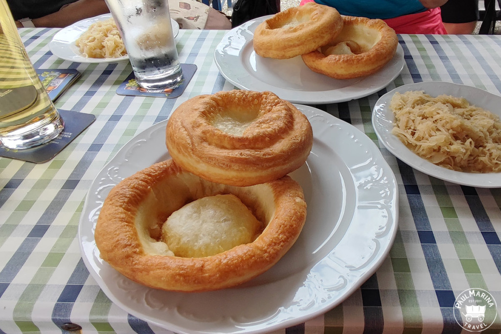 Germkiachl (also spelled Germkirche) are Tyrolean stretched Doughnuts. They can be topped with Sauerkraut, Lingonberry jam or even apple puree.